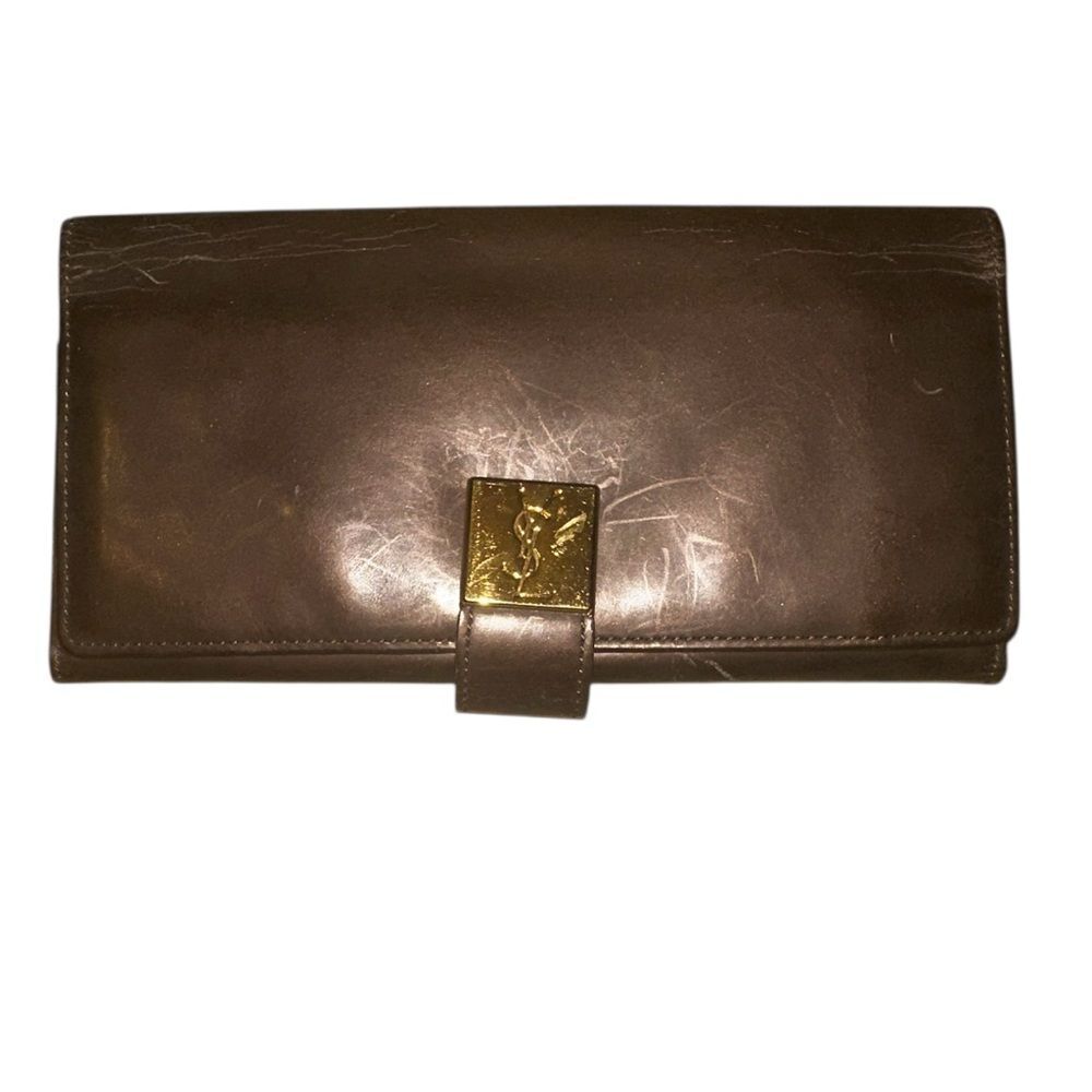 Yves Saint Laurent Tan Leather Wallet with Gold Clasp with marks and scratches.